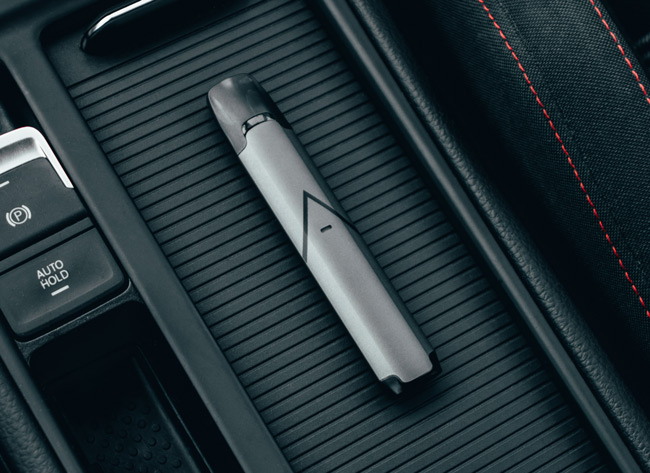 Hexa vape device seated on the centre console of a car.