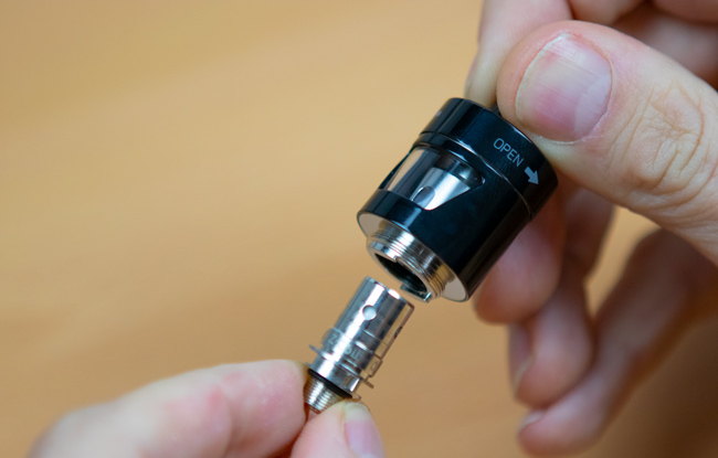 A coil being fitted in to a vape tank