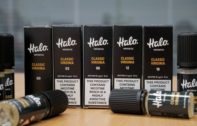 Several bottles of Halo Classic Virginia e-liquids in multiple strength options.