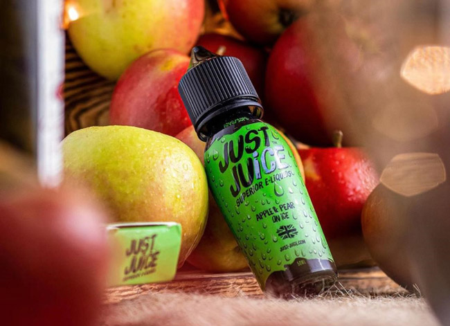 Just Juice Apple & Pear on Ice e-liquid bottle surrounded by apples.